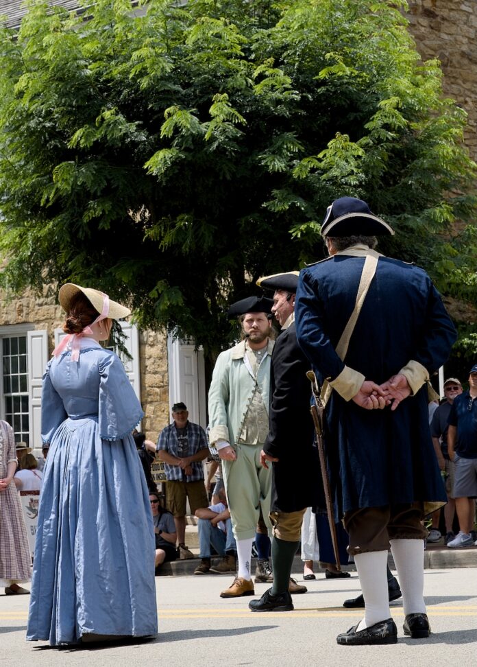 The Whiskey Rebellion Festival is Western Pennsylvania's Biggest History Party Whiskey Rebellion Festival re-enactors stand in the street in discussion.