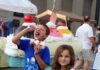 Latrobe Invented the Banana Split, Then Turned Its Sweet Claim to Fame Into One Fabulous Festival Two kids hold banana split as the boy puts the cherry into his mouth.