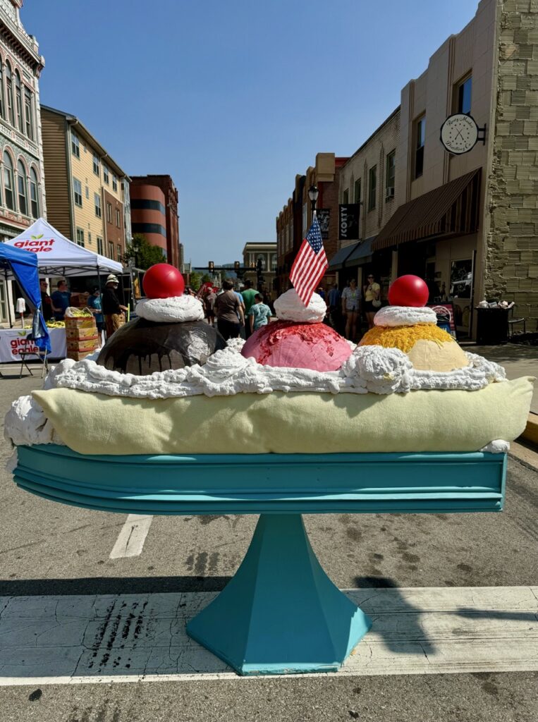 A banana split sculpture in the middle of a street in downtown Latrobe.