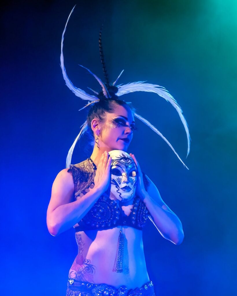 Performer in ornate mask and headdress at Pittsburgh event