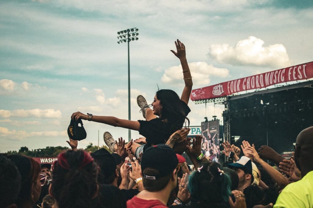 Crowd at Four Chord Music Fest in Pittsburgh, woman crowd surfing