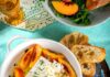 Spiced Pickled Peaches Spiced pickled peaches served in a bowl with white cheese and toasted baguette.