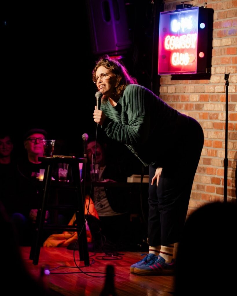 Comedian on stage at Pittsburgh Improv, performing at a comedy event.