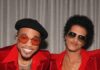 Bruno Mars at Acrisure Stadium: What to Know Before You Go Bruno Mars and Anderson .Paak in red suits with sunglasses on in front of a silver curtain.