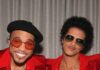 Bruno Mars at Acrisure Stadium: What to Know Before You Go Bruno Mars and Anderson .Paak in red suits with sunglasses on in front of a silver curtain.