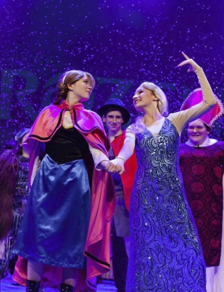 Anna and Elsa perform on stage at a Pittsburgh event.