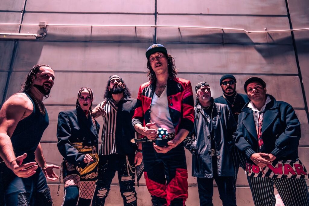 Pittsburgh band posing for a photo with a disco ball, promoting local events.