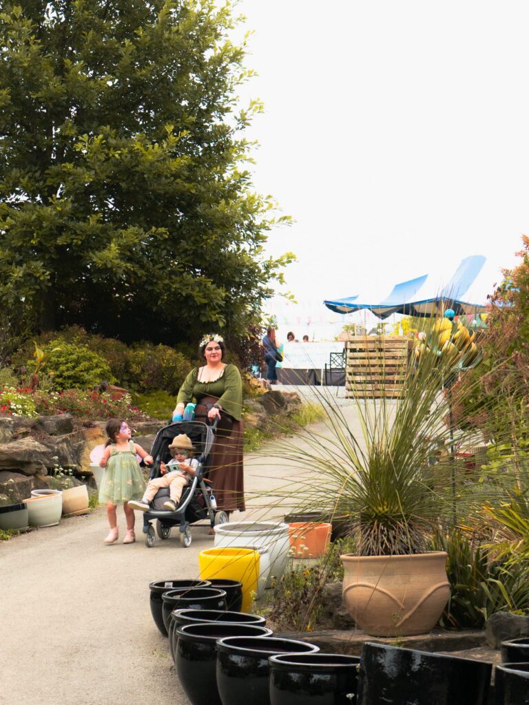 Woman in costume with kids at a Pittsburgh event in a garden