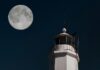 Your July 2026 Horoscope for the Full Moon in Aquarius A full moon beside a tall white light house.