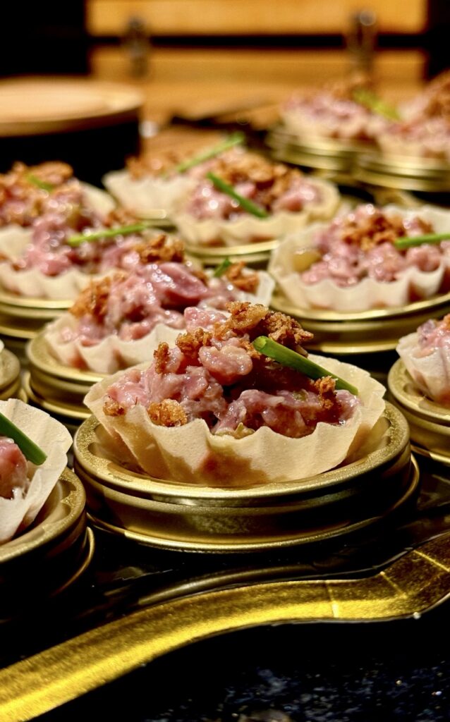 Small tarts of beef wagyu on a tray.
