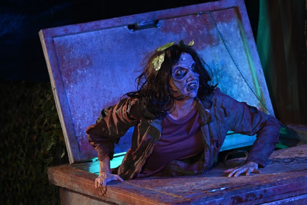 Zombie emerging from a trunk at a Pittsburgh Halloween event.