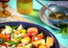 Peach and Tomato ‘Pantoush’ Salad Peach and tomato pantoush salad with toasted bread, feta, and fresh herbs in a blue bowl.