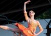 Get a First Look at Pittsburgh Ballet Theatre’s New ‘Nutcracker’ This Weekend A male ballet dancer lifts another woman in the air in orange outfits.