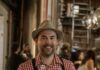 Pittsburgh Oktoberfest 2026: The Ultimate Guide to German Beer, Lagering Caves, and Dachshund Races A man in german clothing and a hat holds a glass of beer.