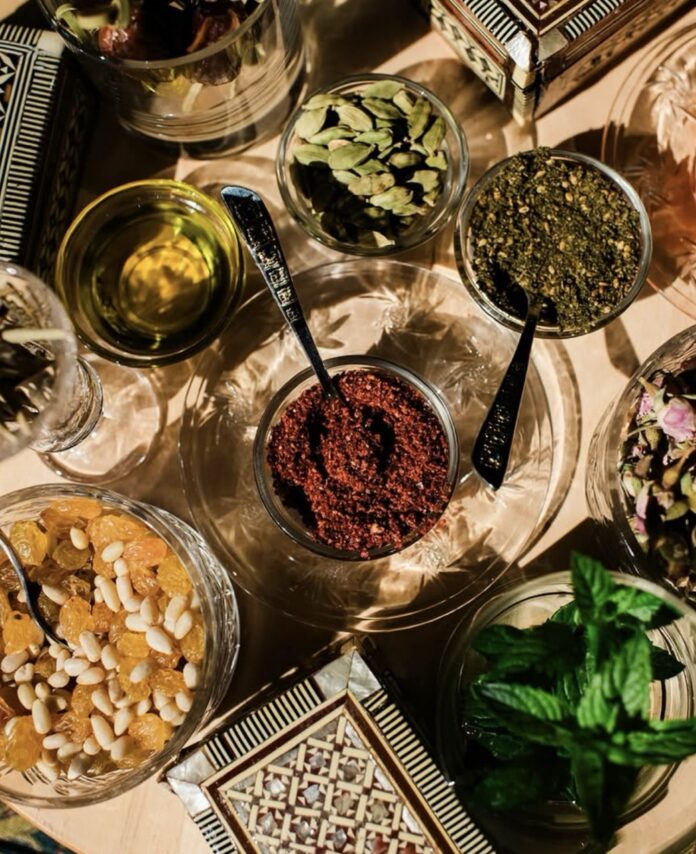 A variety of spices and sauces in bowls on a table.