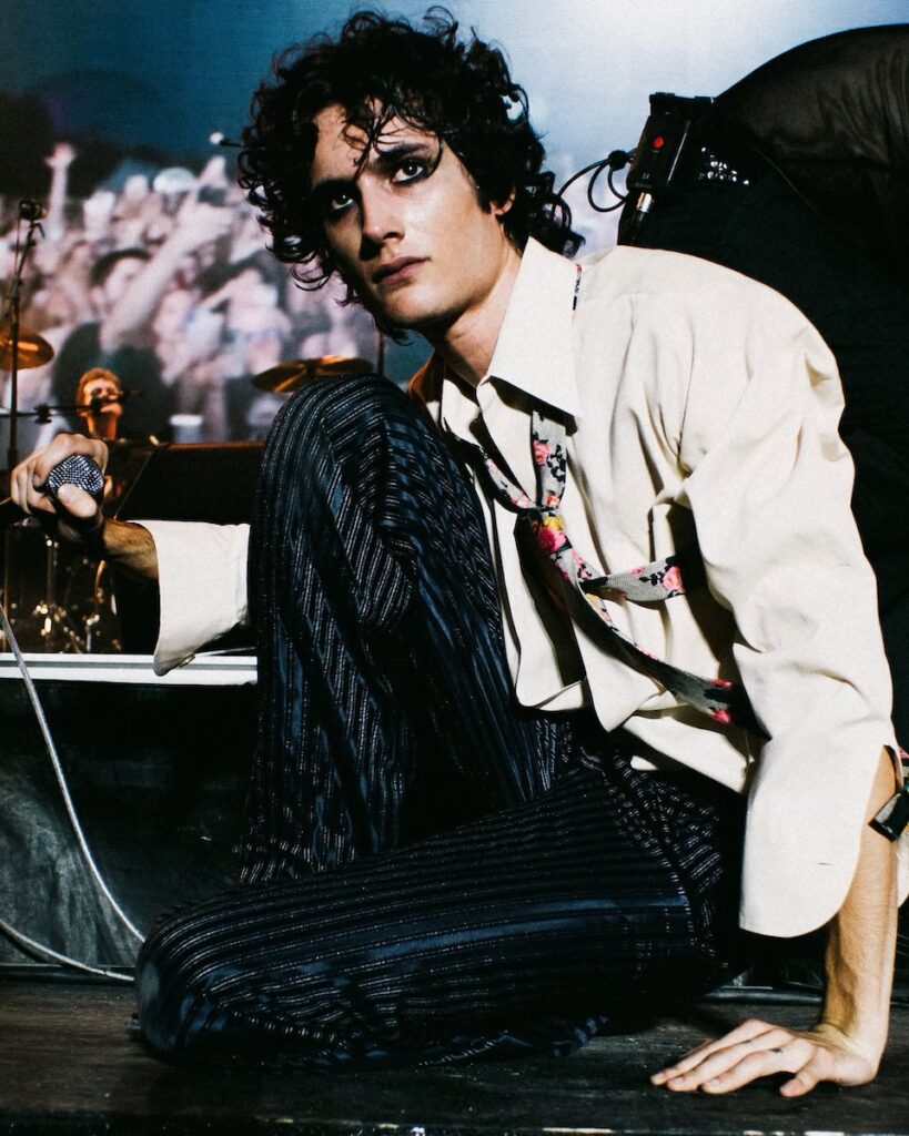 Musician with dramatic eye makeup on stage at a Pittsburgh event