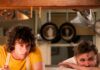 Collier’s Cuts: Anthony Bourdain’s Origin Story Hits the Big Screen in ‘Tony’ Dominic Sessa's character in Tony in a yellow shirt and apron behind a restaurant window with a Chef.