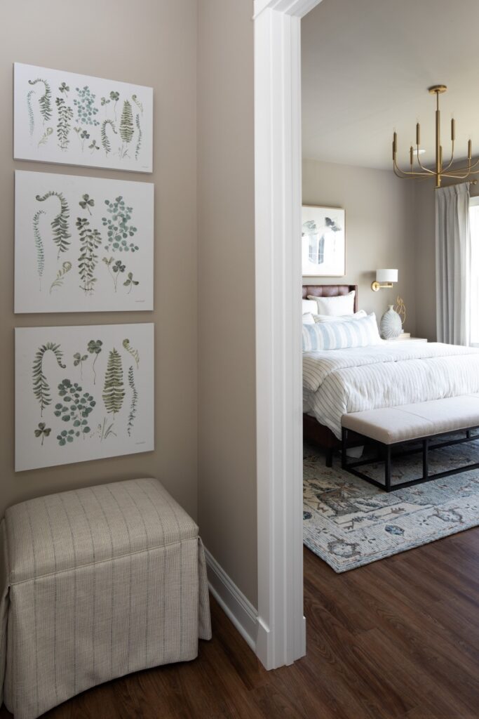 Elegant Pittsburgh bedroom hallway with botanical wall art and brass chandelier.