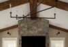 Top Home Building and Remodeling Resources in Pittsburgh Modern Pittsburgh living room with stone fireplace, vaulted wood beams, and black chandelier.