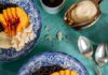 Vegan Black Rice Breakfast Bowl With Peaches Black rice breakfast bowl with sliced peaches, coconut, and almonds in a blue patterned bowl.