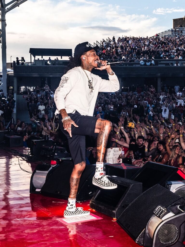 Wiz Khalifa performs at a Pittsburgh event, engaging a large crowd.