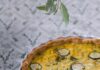 Zucchini Quiche Inspired by Alison Roman A white ceramic tray with a zucchini quiche inside in a golden color.