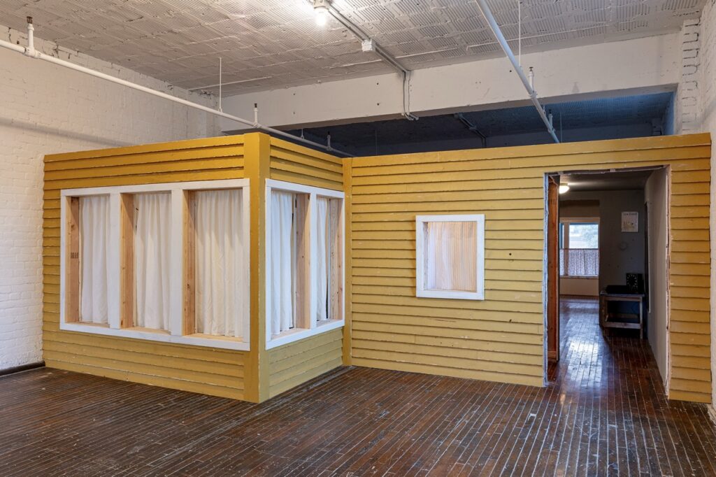 Amanda Ross-Ho's childhood home installation at Mattress Factory, yellow facade.