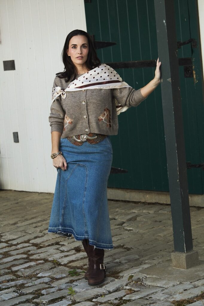 Woman in a denim midi skirt and giraffe cardigan, autumn fashion in Pittsburgh.