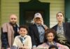 Pittsburgh Autumn Fashion: How to Layer Local Vintage and Boutique Styles A group portrait of eight people of various ages wearing layered autumn fashion on a porch, styled with hats, blazers, and knits.