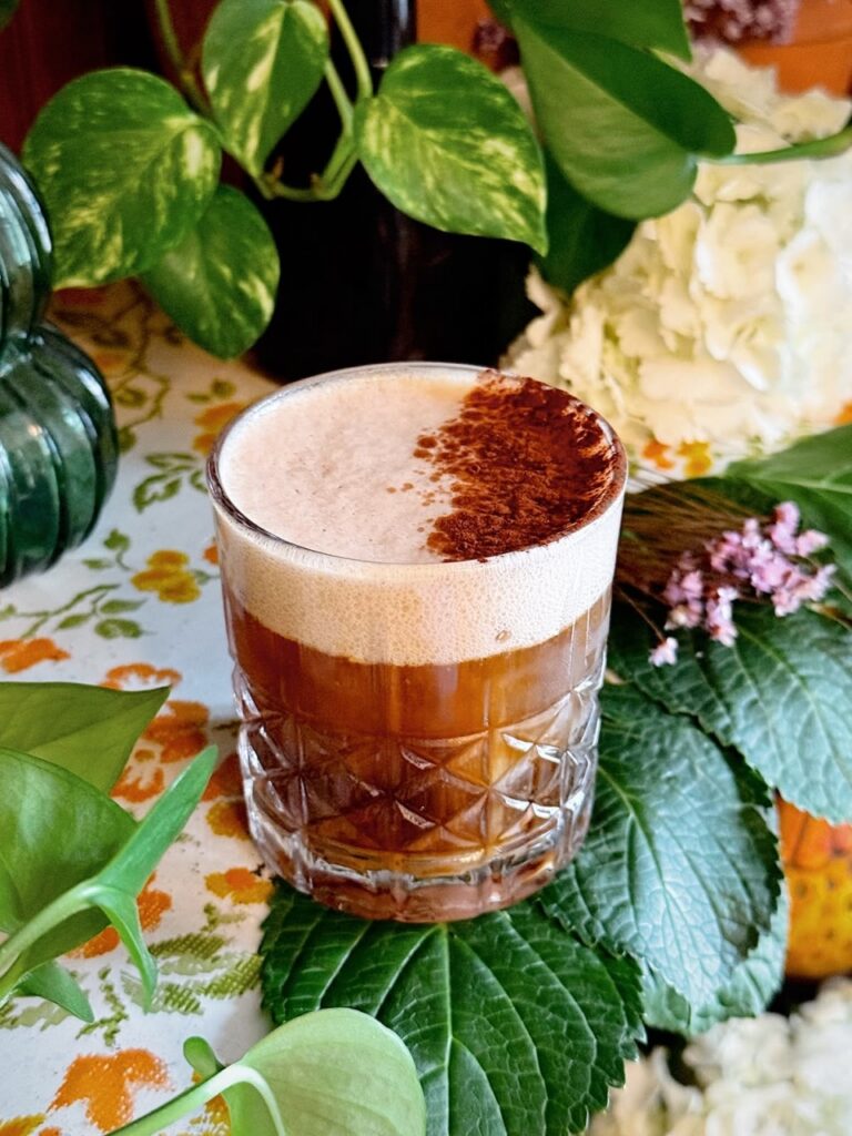 Espresso drink with foam and cinnamon in a textured glass, a Pittsburgh coffee.