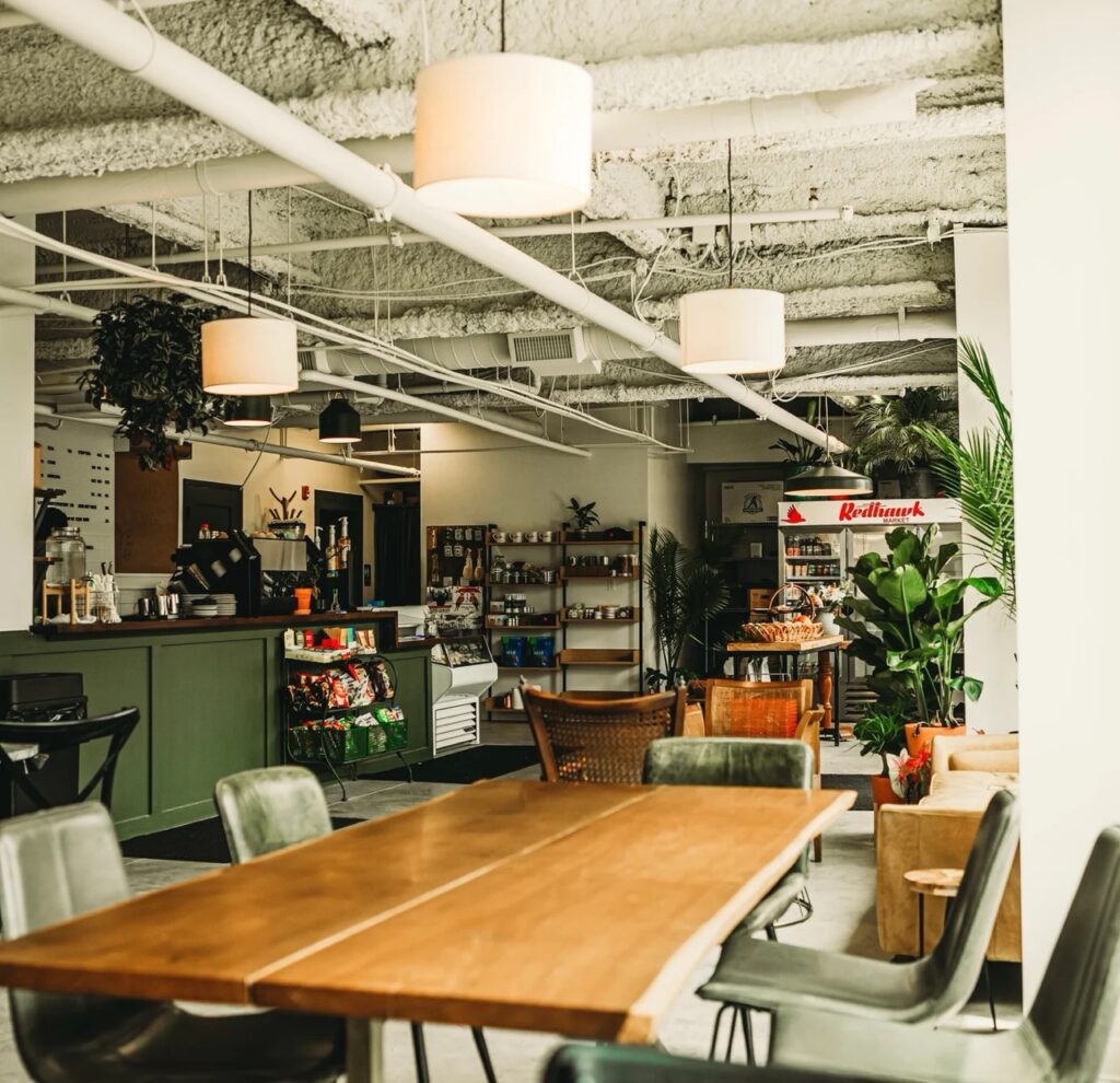 Modern coffee shop interior with wooden tables and seating.