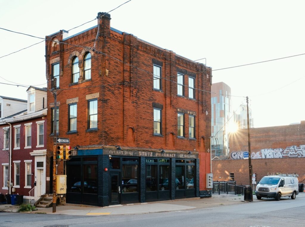 Stutz Pharmacy and Echo Ghost cafe in Pittsburgh, with a van outside.