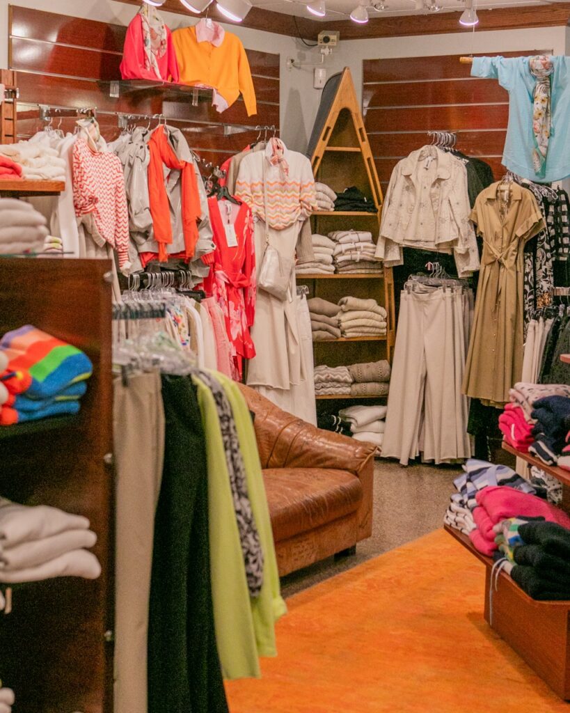 Carabella boutique interior with colorful women's clothing and leather couch