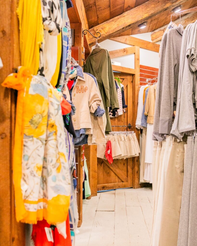 Carabella boutique in Oakmont: colorful clothing racks and wooden interior