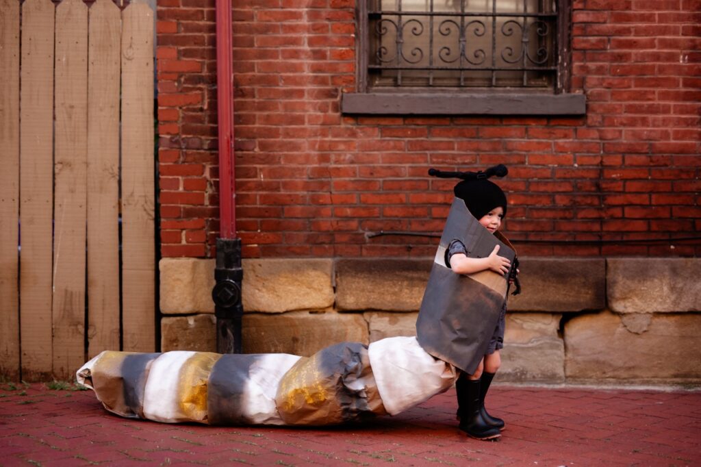 Child in DIY caterpillar Halloween costume, a homemade nature costume.