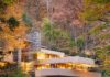 3 Things You Didn’t Know About Fallingwater and Frank Lloyd Wright Fallingwater house by Frank Lloyd Wright integrated with a waterfall and autumn foliage.