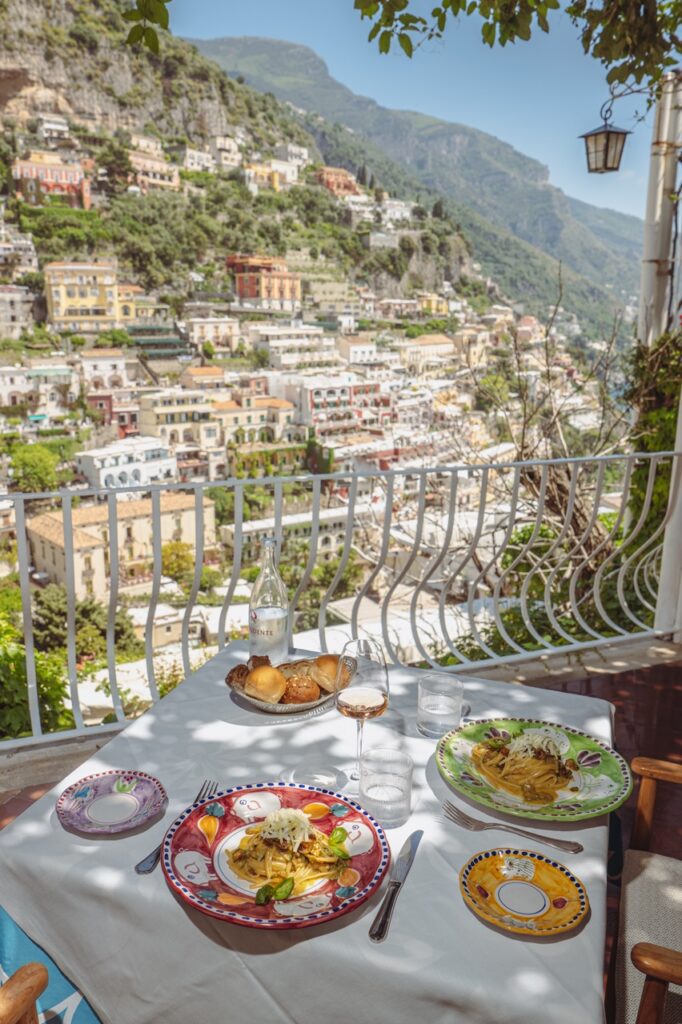 Positano restaurant table with food and views of Hotel Poseidon