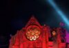 Hundred Acres Manor Guide: Tickets, How Scary Is It & Insider Tips Scary Hundred Acres Manor facade at night with red and blue lights, offering tickets.