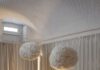 Dispatch From Milan Design Week: New Ways to Bring Comfort and Calm to Interiors Plush cream sofa and fluffy pendant lights in a modern living room