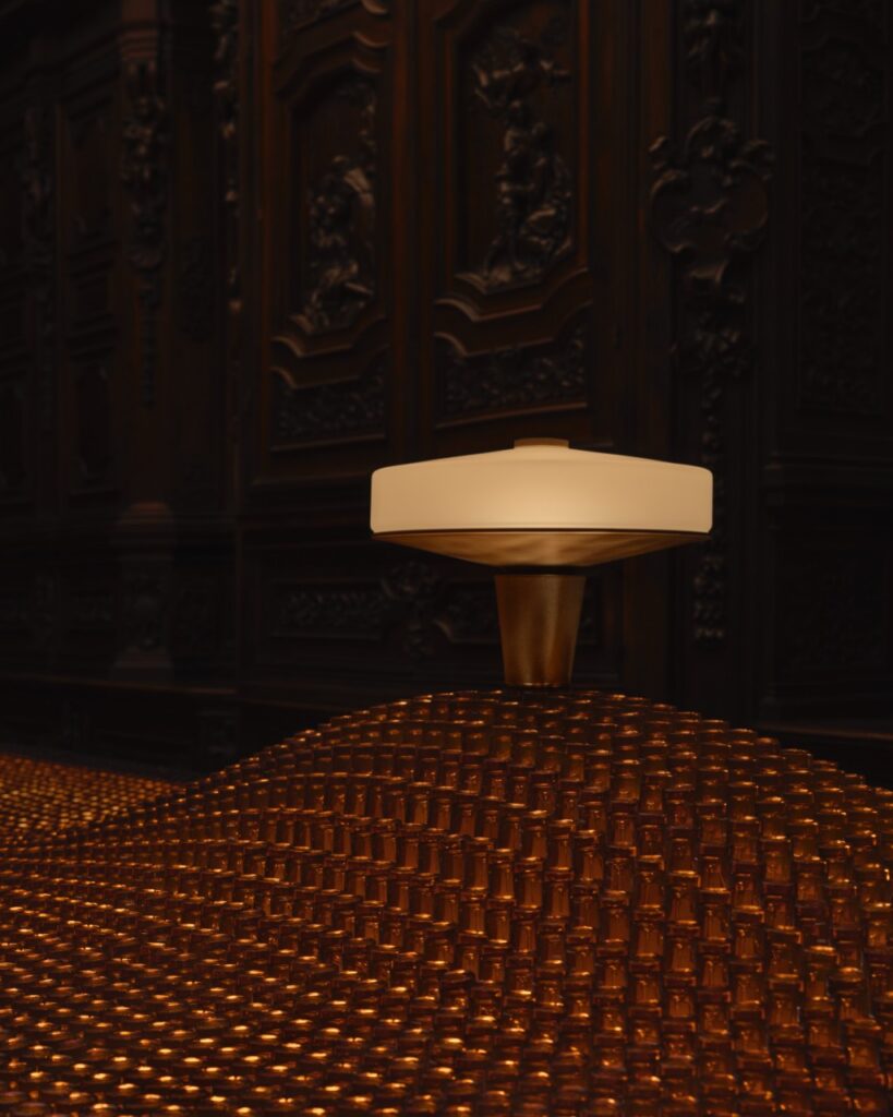 Milan Design Week: Textured surface with a modern lamp, evoking comfort and calm interiors.