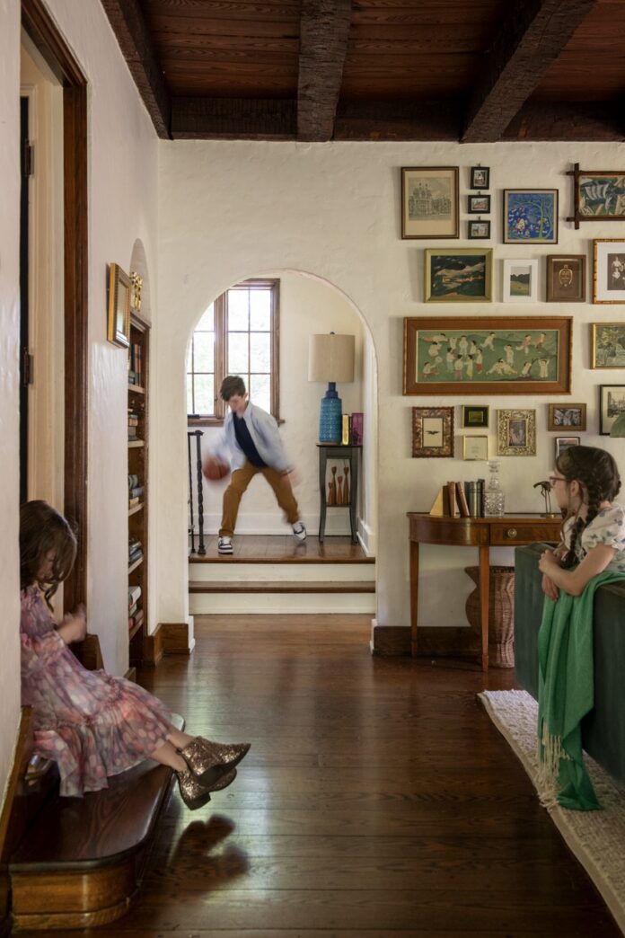 Children playing in a charming Mt. Lebanon fairy tale cottage hallway by Ali Harvey