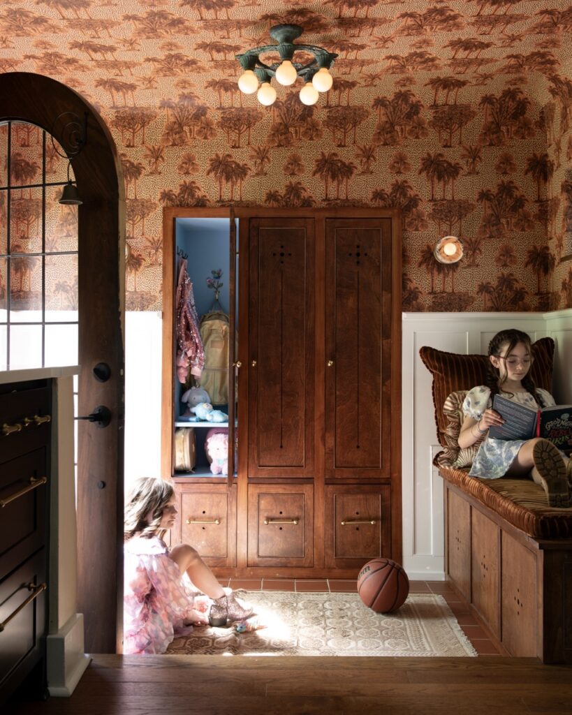 Interior designer Ali Harvey's Mt. Lebanon cottage: Two girls in a whimsical hallway with a wooden armoire.