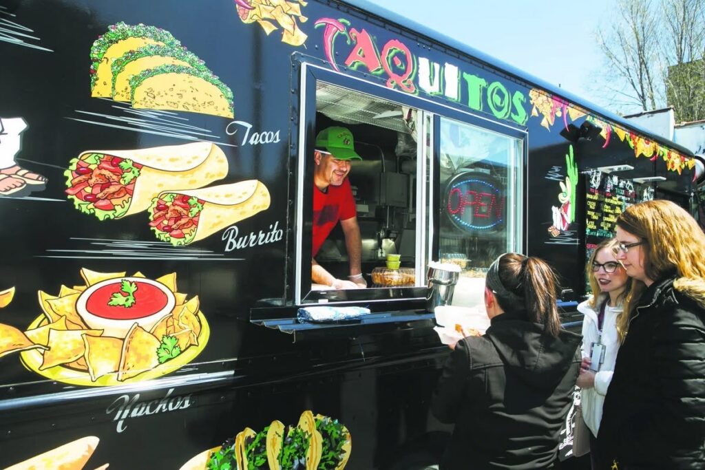 Taquitos food truck at a Pittsburgh night market, serving tacos and burritos.
