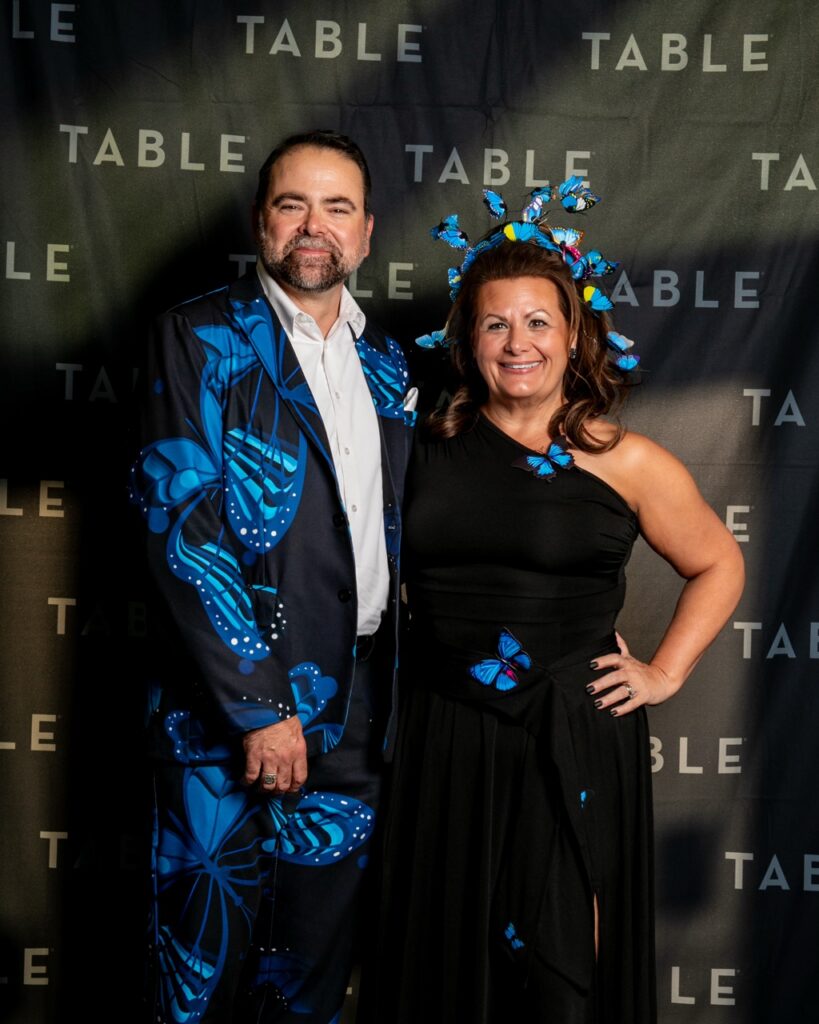 Couple in butterfly-themed outfits at a TABLE event