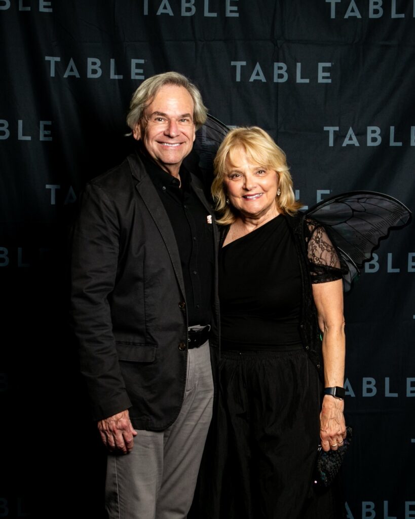 Couple dressed for a formal event with fairy wings