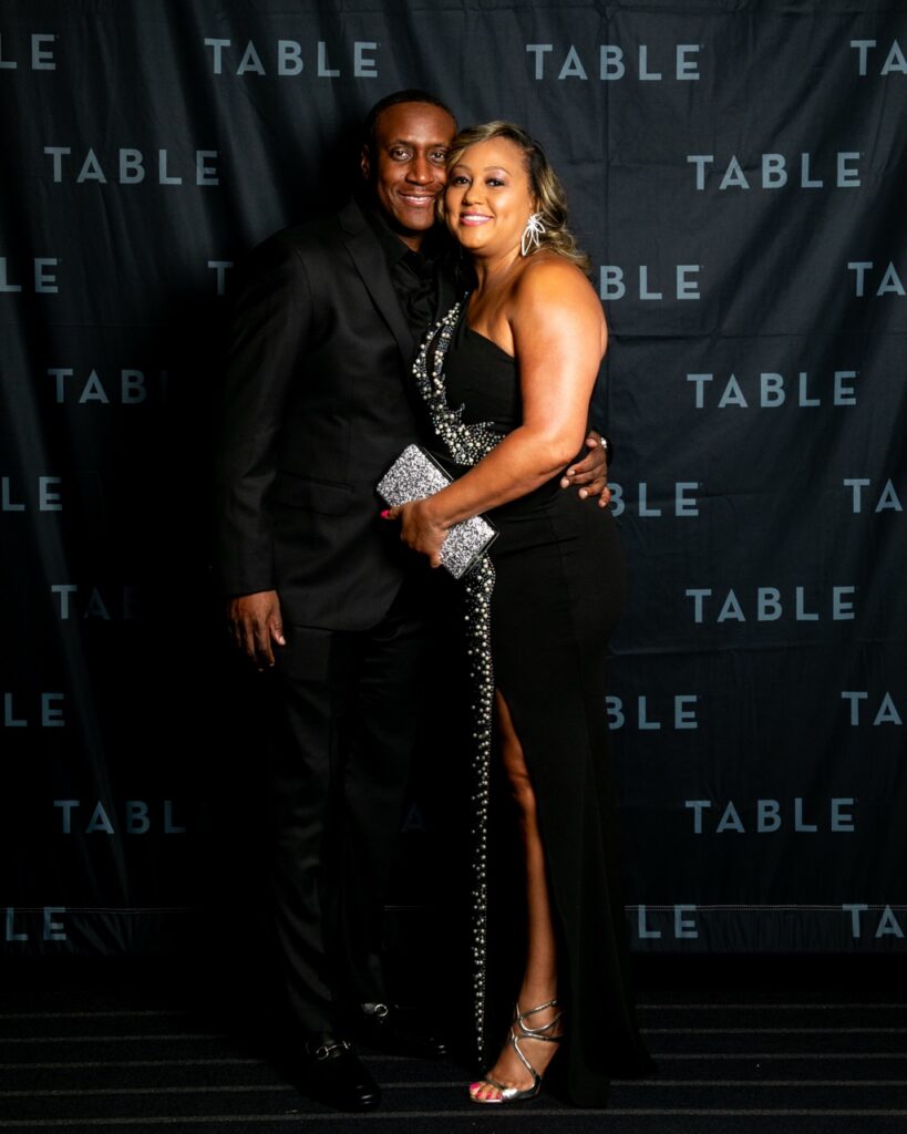 Couple in formal black attire at a TABLE event