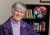 Sister Shelly Farabaugh: Prioress of the Benedictine Sisters of Pittsburgh Elderly woman with short gray hair and glasses smiles, holding a book and mug.