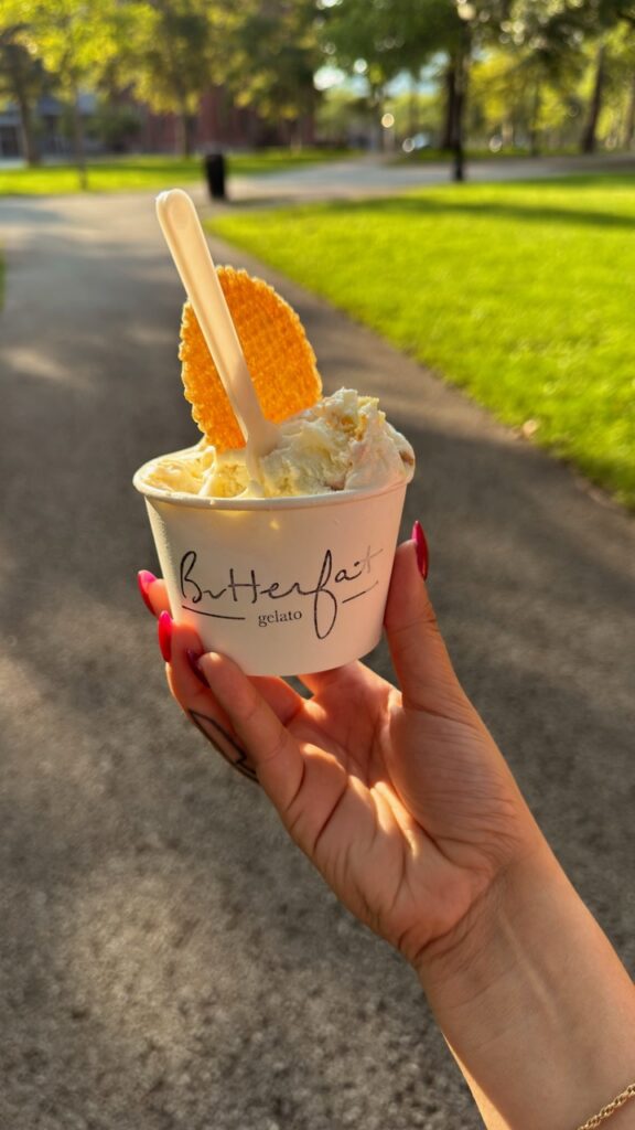 Hand holding Buttercream gelato cup with waffle crisp in Pittsburgh park