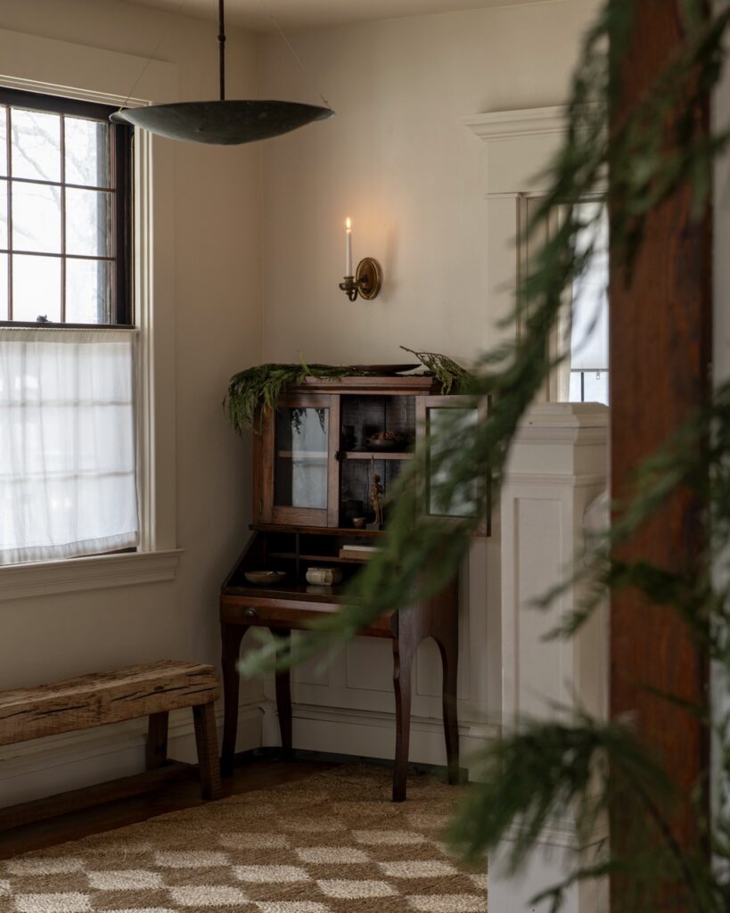 Erin Kelly's natural holiday decor: wooden desk with foraged greenery