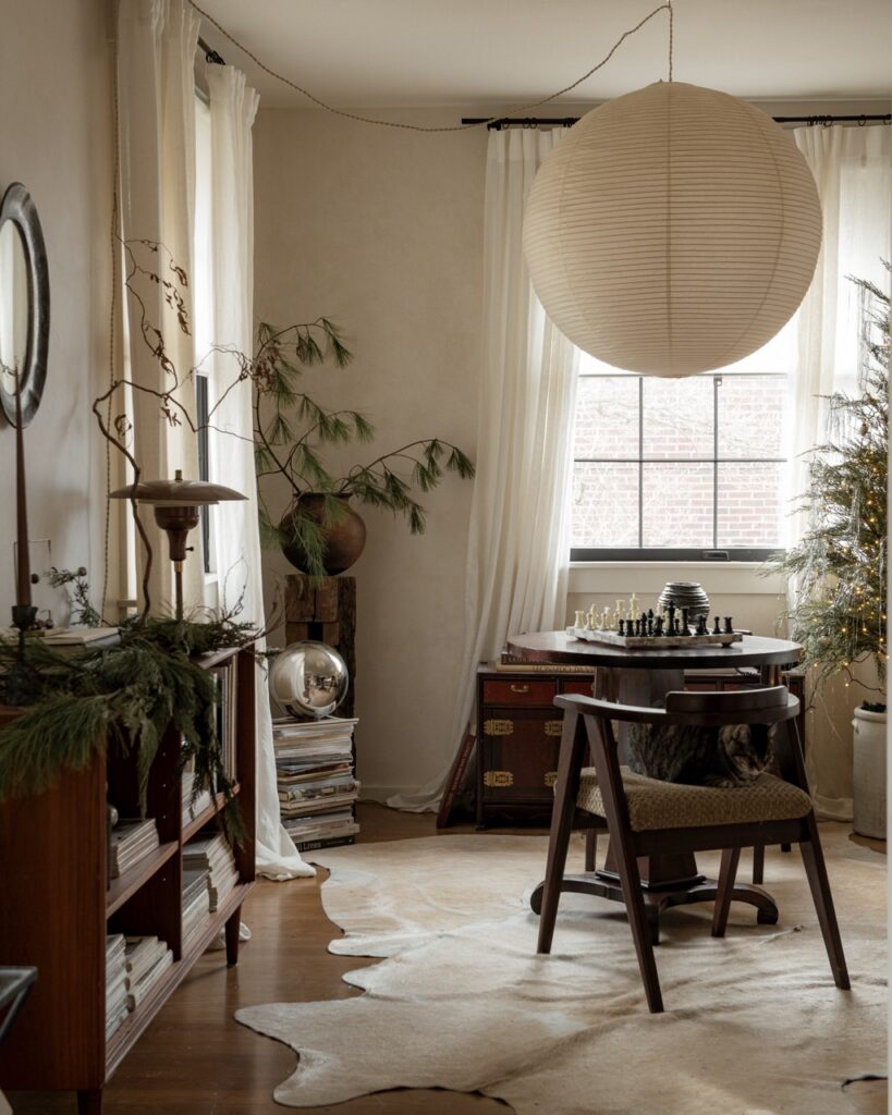 Foraged holiday decor in a cozy room with a cat on a chair